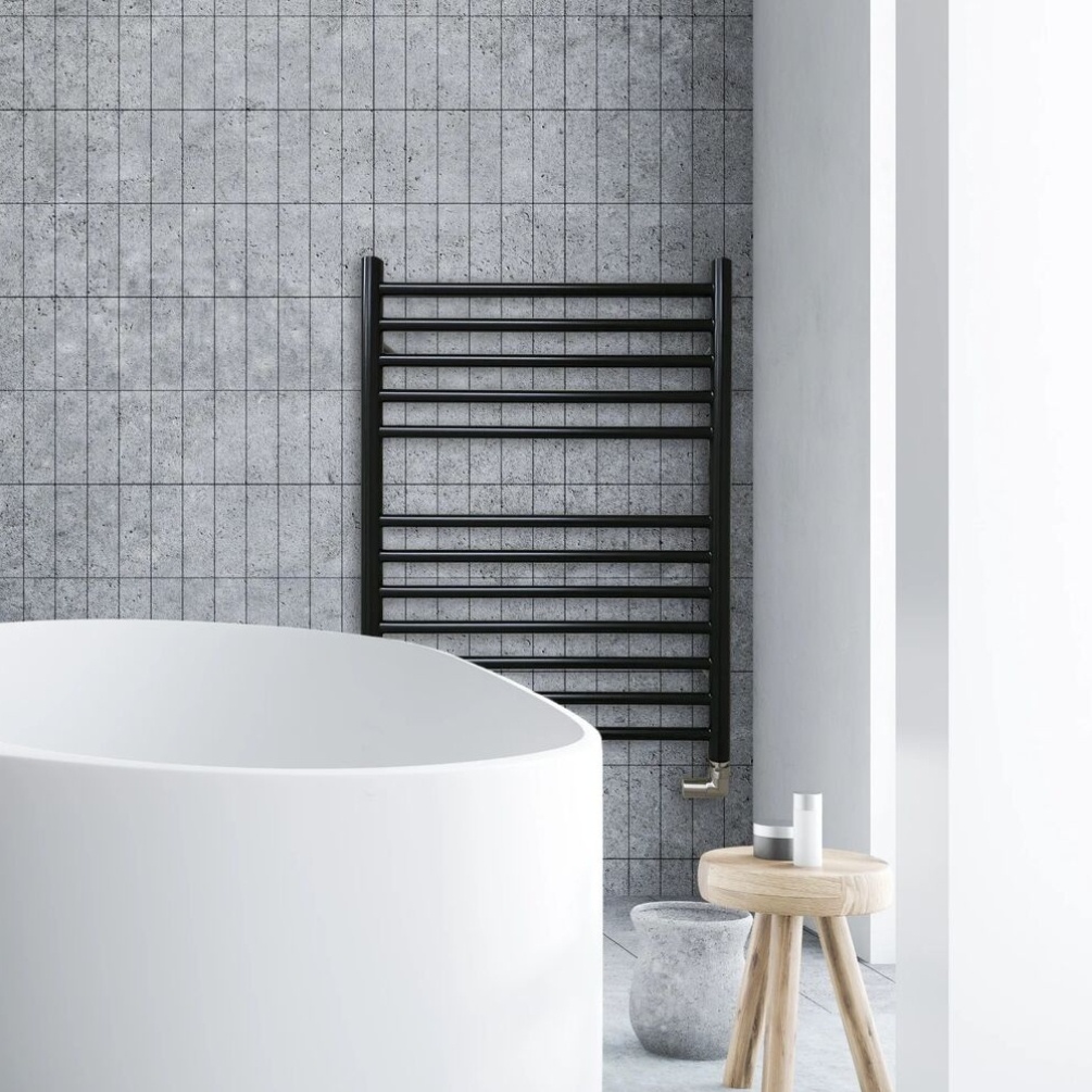Lifestyle image of the The Sussex Range by JIS Ouse 700mm x 520mm Black Heated Towel Rail installed behind a freestanding bathtub